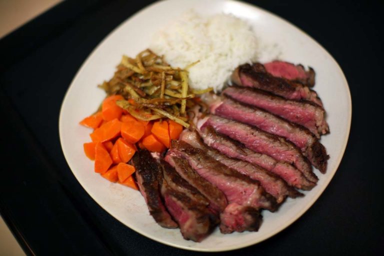 Frying ribeye shop steak in pan